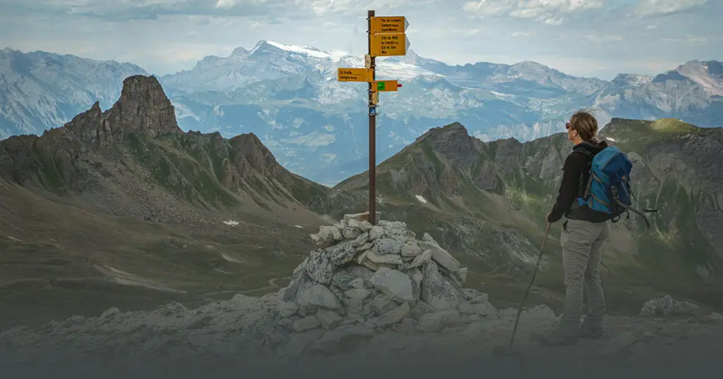 hiker looking at sign post